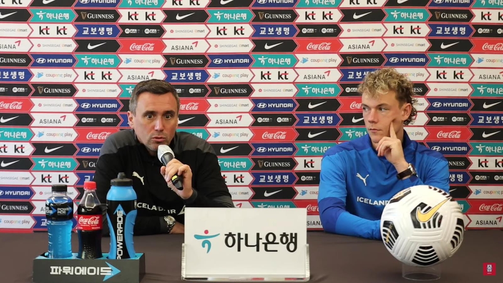 Arnar Vidarsson (L), head coach of the Iceland men's national football team, and defender Hoskuldur Gunnlaugsson attend an online press conference on Nov. 10, 2022, the eve of a friendly match against South Korea, in this photo captured from the YouTube footage of the presser. (PHOTO NOT FOR SALE) (Yonhap)