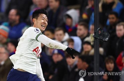 In this Reuters photo, Son Heung-min of Tottenham Hotspur throws away his mask to celebrate his goal against Crystal Palace during the clubs' Premier League match at Selhurst Park in London on Jan. 4, 2023. (Yonhap)