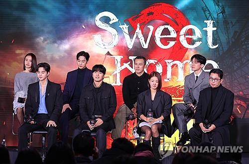 Cast members and director Lee Eung-bok (far R, front row) of "Sweet Home 2" attend a media event in Seoul on Nov. 30, 2023, one day before the series' premiere on Netflix. (Yonhap)