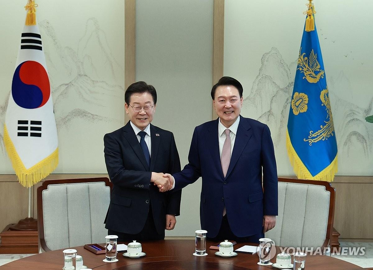 President Yoon Suk Yeol (R) and Democratic Party leader Lee Jae-myung shake hands during their first-ever meeting at the presidential office in Seoul on April 29, 2024. (Yonhap)