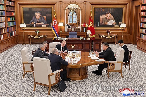 North Korean leader Kim Jong-un (R, at table) talks with Russia's Security Council Secretary Sergei Shoigu (far L) during their meeting in Pyongyang on June 4, 2025, in this file photo released by the North's official Korean Central News Agency the next day. The two sides discussed cooperation in various fields and exchanged views on the situation surrounding the Ukrainian crisis and the Korean Peninsula. (For Use Only in the Republic of Korea. No Redistribution) (Yonhap)