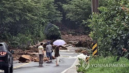 Trees and debris are scattered along a road following heavy rain in the southern county of Sancheong on July 19, 2025, in this photo provided by a reader. (PHOTO NOT FOR SALE) (Yonhap)