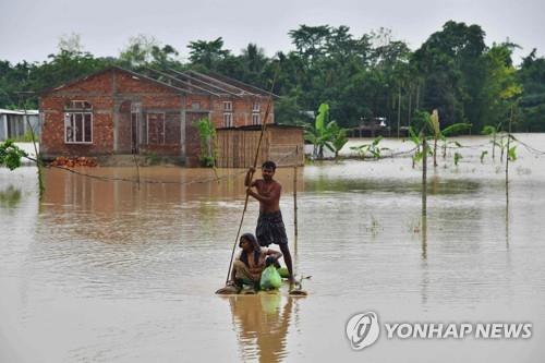 21일 홍수로 물에 잠긴 인도 아삼주의 한 마을.