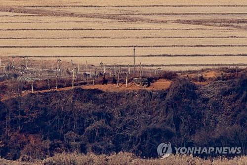 La foto, tomada, el 5 de enero de 2022, desde un mirador en Paju, al norte de Seúl, muestra a soldados norcoreanos caminando a lo largo de una cerca de alambre de púas, en la aldea fronteriza occidental de Kaepung, en la provincia de Hwanghae del Norte, cuando Corea del Norte lanzó lo que pareció ser un misil balístico hacia el mar de Este, alrededor de las 8:10 a.m., desde una plataforma terrestre.