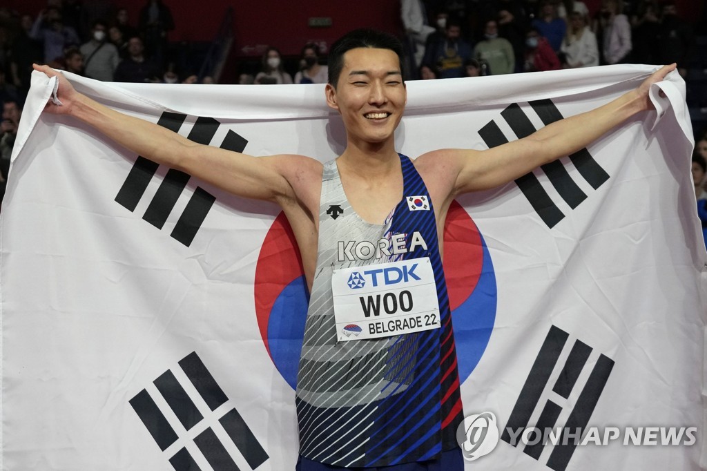 In this Associated Press file photo from March 20, 2022, Woo Sang-hyeok of South Korea celebrates after winning the men's high jump title at the World Athletics Indoor Championships at Stark Arena in Belgrade. (Yonhap)