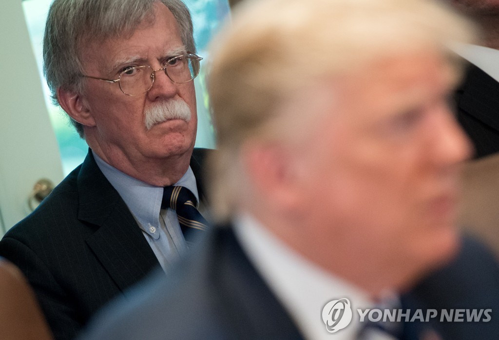 This AFP photo shows former U.S. National Security Adviser John Bolton (L) during a cabinet meeting with President Donald Trump at the White House on May 9, 2018. (Yonhap)