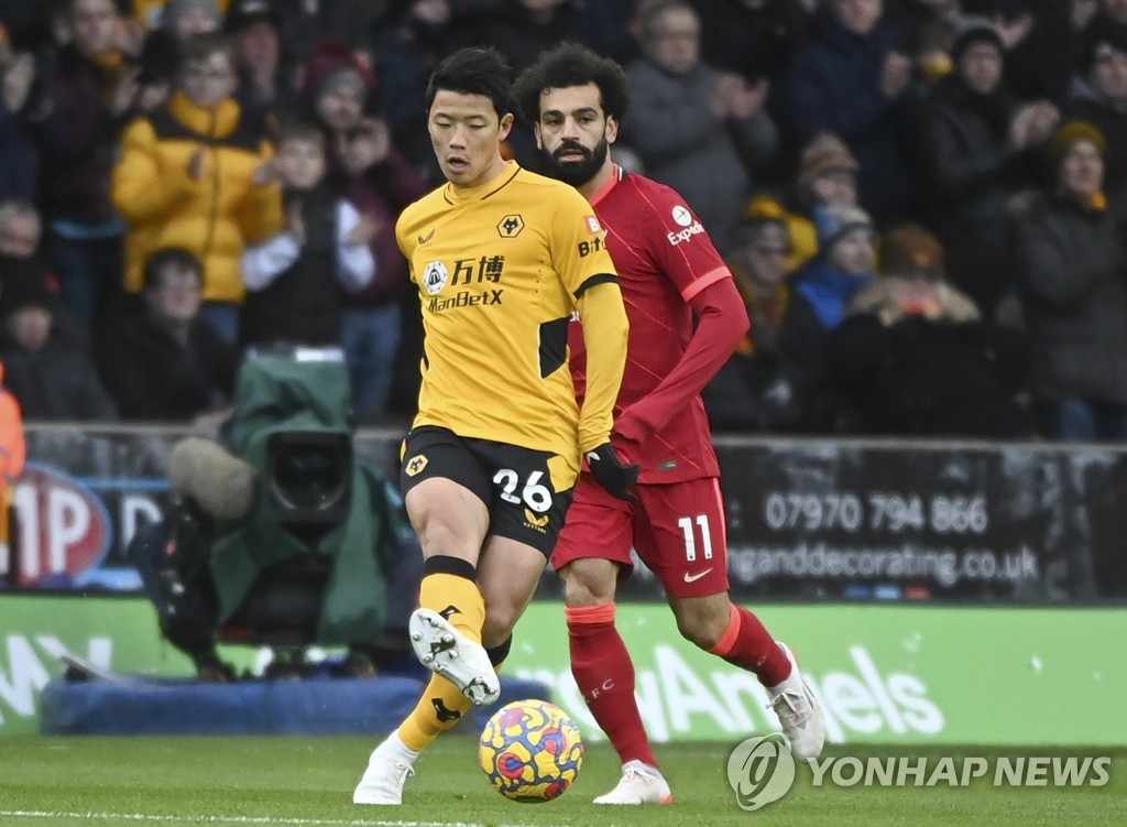 In this EPA file photo from Dec. 4, 2021, Hwang Hee-chan of Wolverhampton Wanderers (L) is in action against Mohamed Salah of Liverpool during the clubs' Premier League match at Molineux Stadium in Wolverhampton, England. (Yonhap)