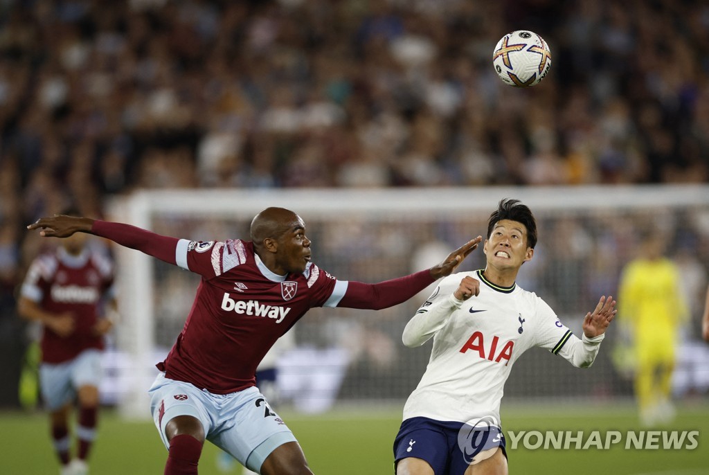 In this Action Images photo via Reuters, Son Heung-min of Tottenham Hotspur (R) battles Angelo Ogbonna of West Ham United for the ball during the clubs' Premier League match at London Stadium in London on Aug. 31, 2022. (Yonhap)
