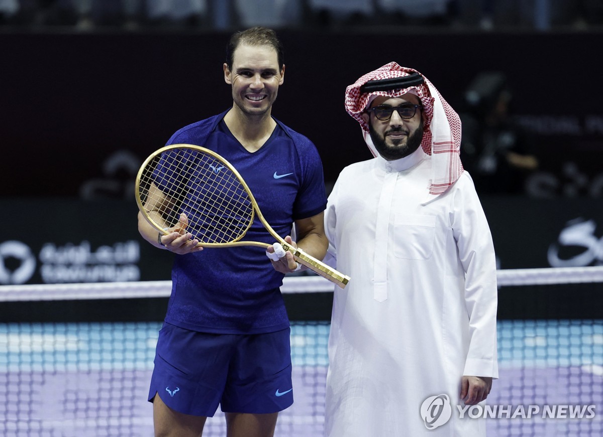 Nadal (left) receiving a golden racket as a gift