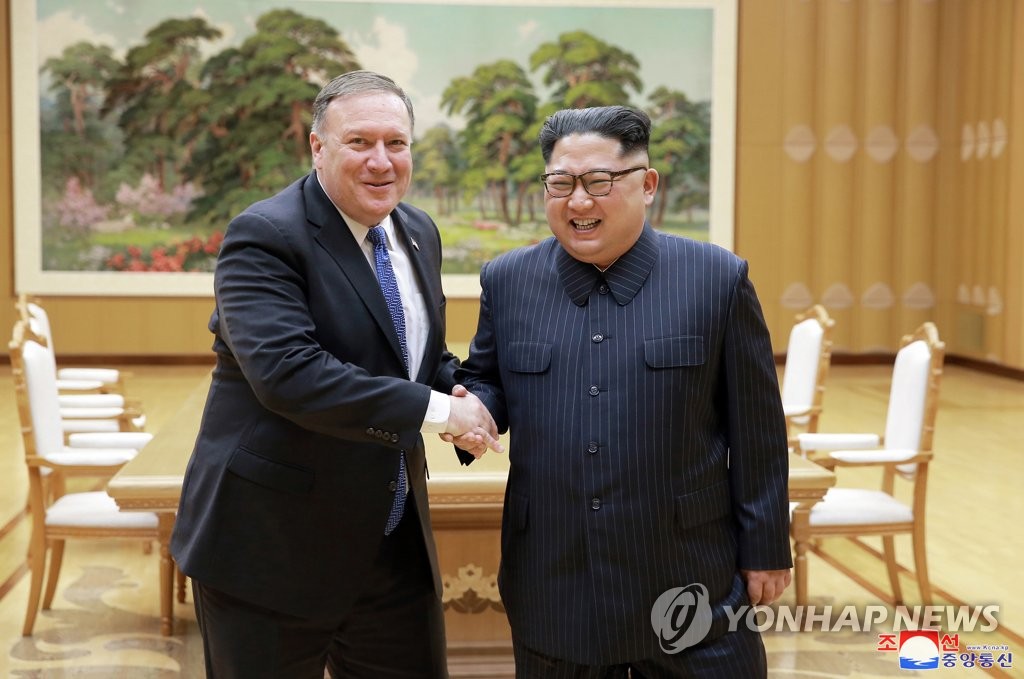 This photo, provided by North Korea's Korean Central News Agency, shows North Korean leader Kim Jong-un (R) shaking hands with then U.S. Secretary of State Mike Pompeo in Pyongyang on May 9, 2018. (For Use Only in the Republic of Korea. No Redistribution) (Yonhap)