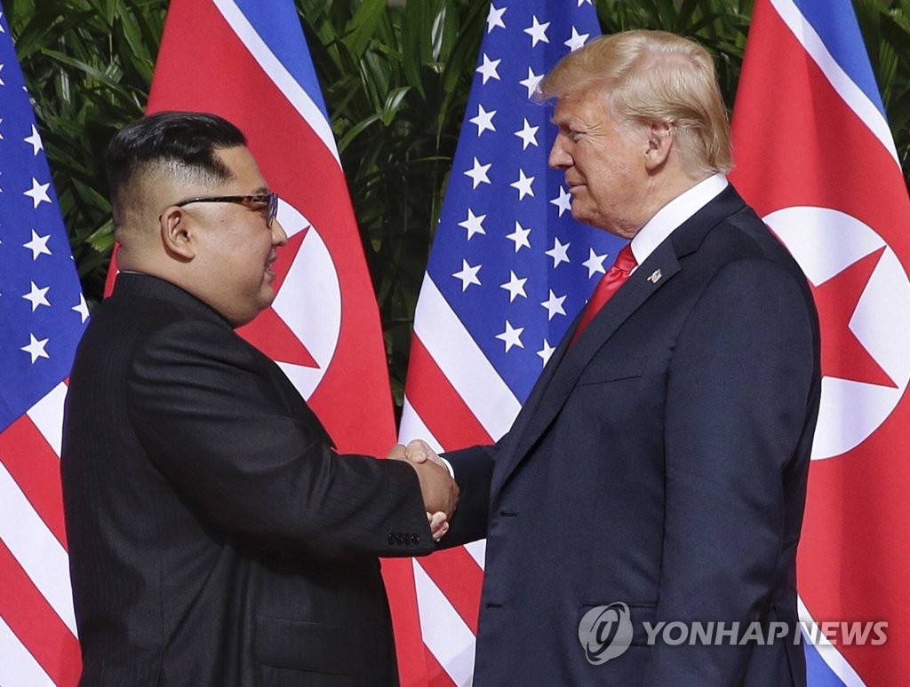 This EPA photo shows North Korean leader Kim Jong-un (L) and U.S. President Donald Trump meeting in Singapore on June 12, 2018. (Yonhap)