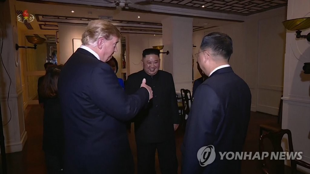 U.S. President Donald Trump (L) gives a thumbs-up to Kim Yong-chol, a senior North Korean official in high-level talks with the United States, as the North's leader, Kim Jong-un (C), looks on during a pre-dinner chat in this image captured from a documentary aired by the North's Korean Central TV on March 6, 2019. The broadcaster ran a 75-minute feature on the Kim-Trump summit in Hanoi, held Feb. 27-28, which ended without agreement. The documentary, however, said Kim reiterated his will for them to continue to meet more often to improve bilateral relations. (For Use Only in the Republic of Korea. No Redistribution) (Yonhap)