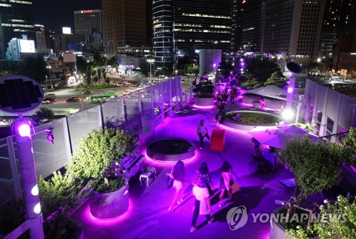 Landmarks in Seoul illuminated in violet to celebrate BTS' fan meeting