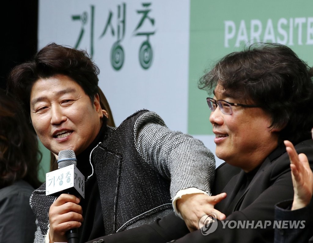 In this file photo, Song Kang-ho (L), who stars in the Oscar-winning Korean film "Parasite," speaks during a press conference at a Seoul hotel on Feb. 19, 2020. Seated next to him is writer-director Bong Joon-ho. (Yonhap)