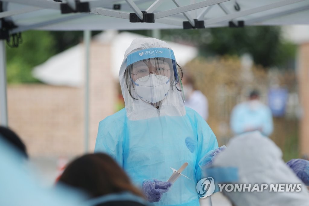 A medical worker carries out new coronavirus tests at a makeshift clinic at a church in Gwangju, 330 kilometers south of Seoul, on July 4, 2020. (Yonhap)