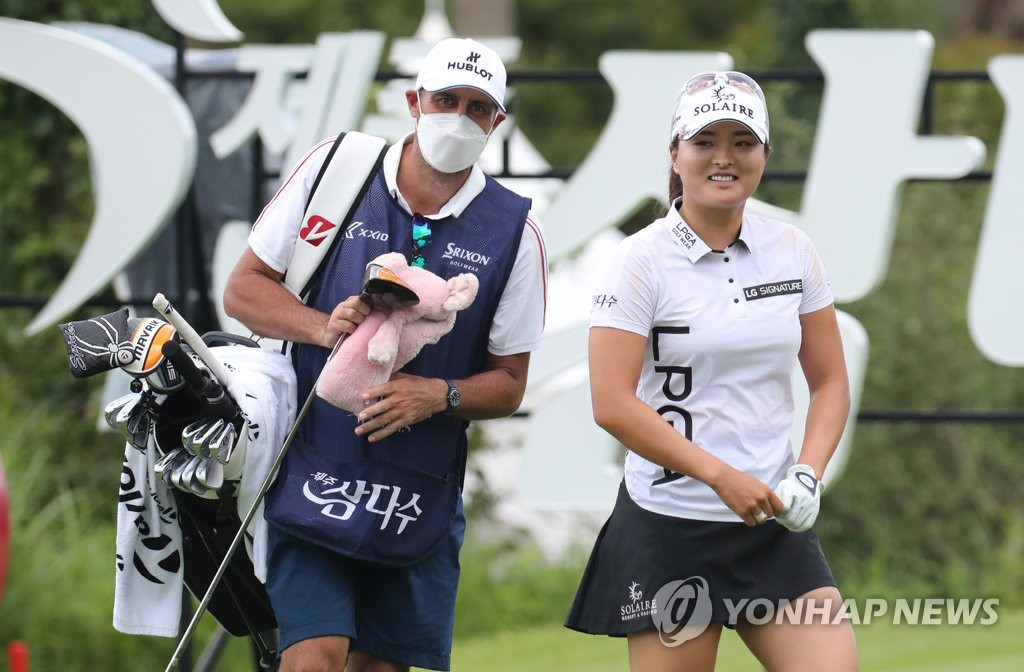 In this file photo from July 30, 2020, Ko Jin-young (R) smiles after hitting her tee shot on the first hole during the first round of the Jeju Samdasoo Masters tournament at Saint Four Golf & Resort in Jeju, Jeju Island. (Yonhap)