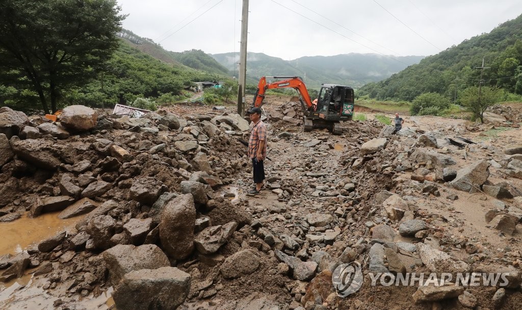 A road in Chungju, North Chungcheong Province, is covered with soil after heavy rain hit the area on Aug. 2, 2020. (Yonhap)