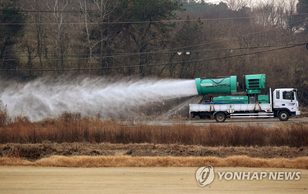 A truck disinfects areas surrounding a duck farm in Jangseong, 252 kilometers south of Seoul, on Dec. 11, 2020. (Yonhap)