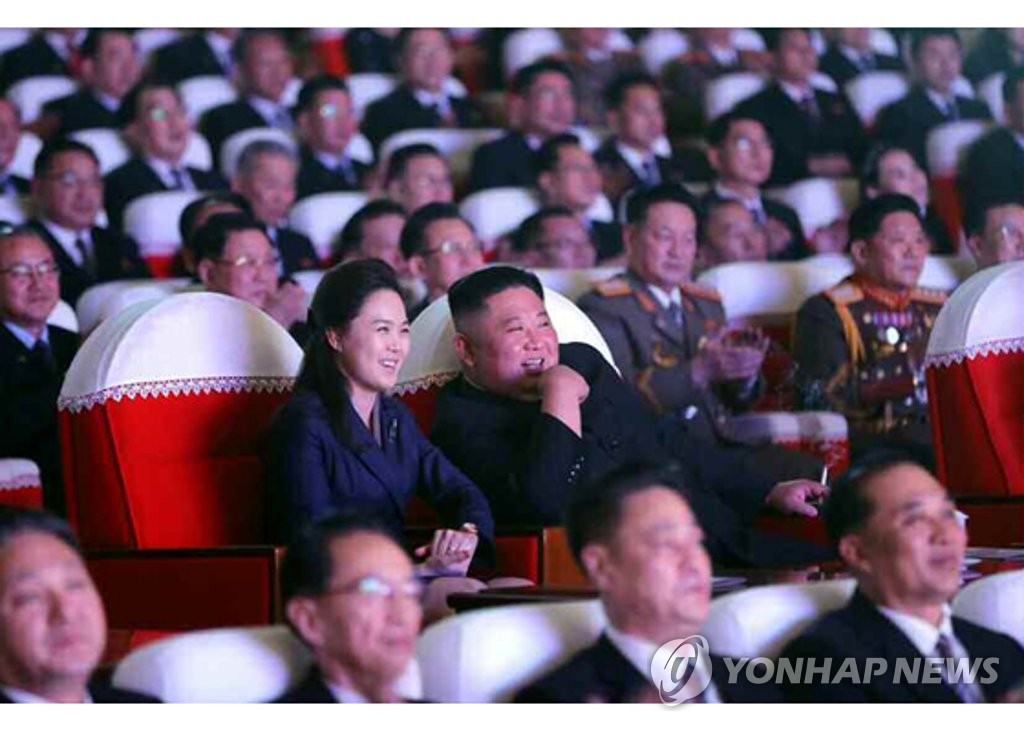 This photo captured from the website of the Rodong Sinmun shows North Korean leader Kim Jong-un and his wife, Ri Sol-ju, watching a performance on Feb. 16, 2021, in commemoration of the birthday of late leader Kim Jong-il. Ri made her first public appearance in more than a year. (For Use Only in the Republic of Korea. No Redistribution) (Yonhap)