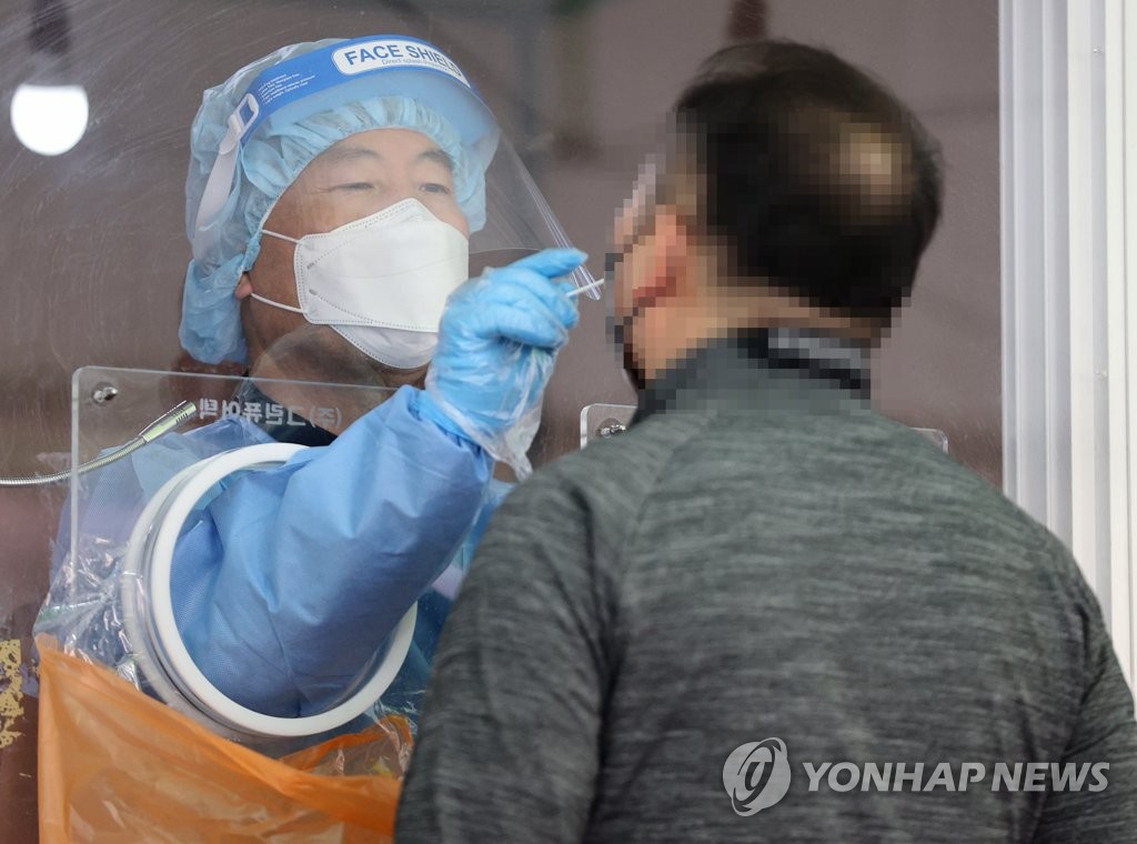 A visitor receives a COVID-19 test at a makeshift clinic in central Seoul on April 7, 2021. (Yonhap)