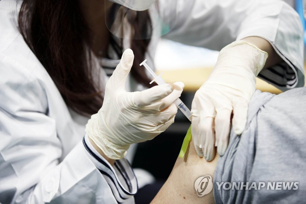 Une membre du personnel médical injecte le vaccin Pfizer à une personne dans un centre de vaccination contre le Covid-19 à Gwangju, à 330 kilomètres au sud de Séoul, le 3 juin 2021. (Photo fournie par le bureau du quartier nord de Gwangju. Revente et archivage interdits)