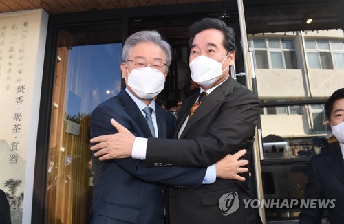 La foto, proporcionada por el cuerpo de prensa, muestra al exlíder del gobernante Partido Democrático, Lee Nak-yon (dcha.), y el gobernador de Gyeonggi, Lee Jae-myung, abrazándose, durante una reunión bilateral, celebrada el 24 de octubre de 2021, en el distrito de Jongno, en el centro de Seúl. (Prohibida su reventa y archivo)