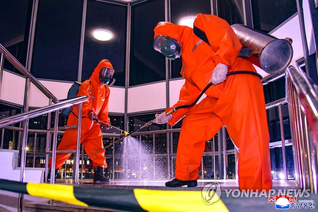 Workers carry out disinfection work in Pyongyang, in this photo released by the North's Korean Central News Agency on June 7, 2022. (For Use Only in the Republic of Korea. No Redistribution) (Yonhap)