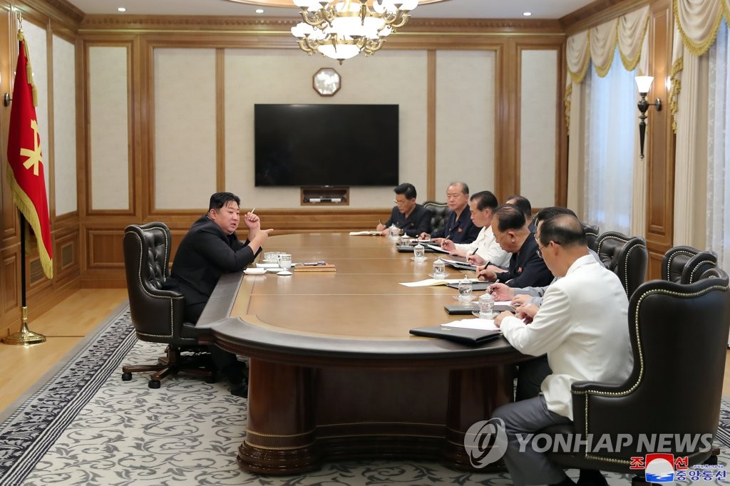 North Korean leader Kim Jong-un (L), holding a cigarette, presides over a meeting of the secretariat of the central committee of the North's Workers' Party in Pyongyang on June 12, 2022, in this photo released by the North's Korean Central News Agency. Participants at the meeting discussed ways to establish and preserve discipline in the party, and wage an intensive struggle against non-revolutionary acts by some party officials, the agency said. (For Use Only in the Republic of Korea. No Redistribution) (Yonhap)
