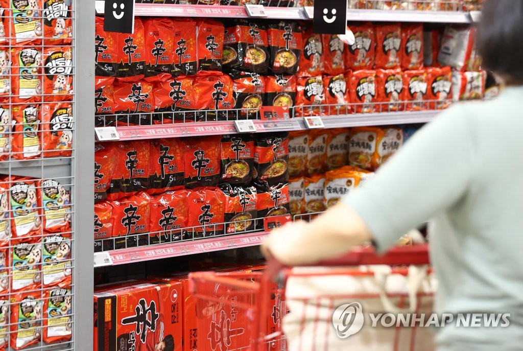 This file photo, taken Sept. 15, 2022, shows a person looking at a shelf of instant noodles at a discount store chain in Seoul. (Yonhap)