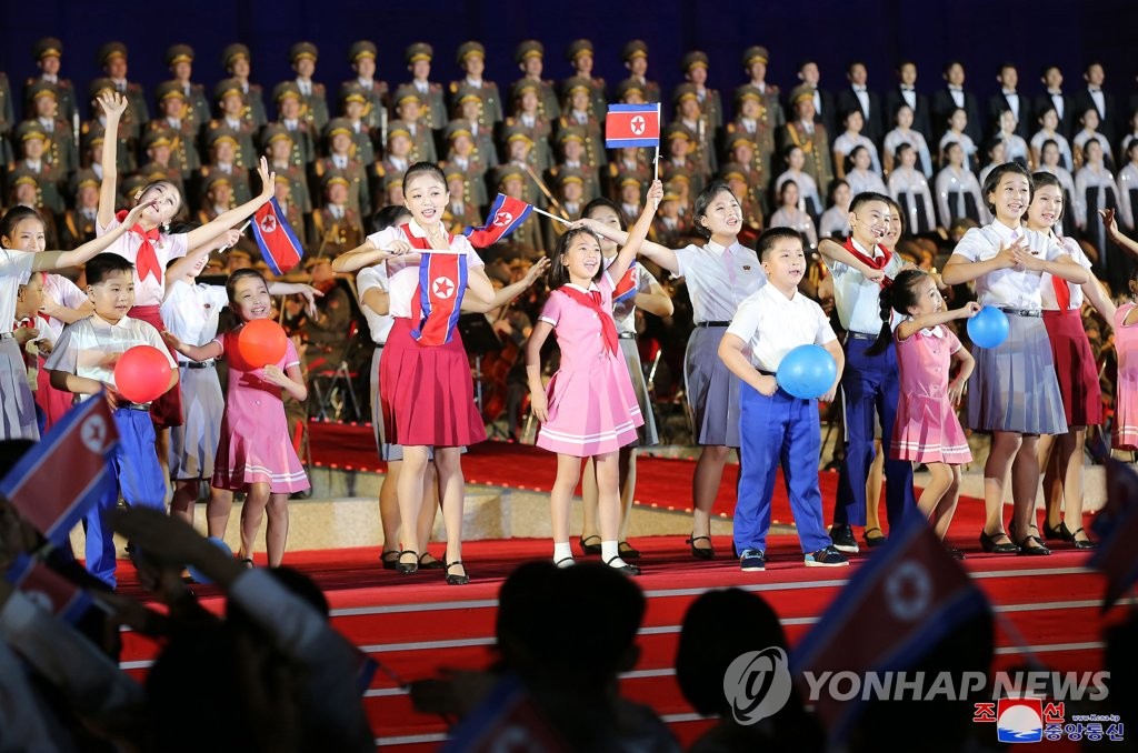 This photo, released by the official Korean Central News Agency on Sept. 9, 2022, shows North Korean children performing at an event marking the 74th anniversary of the state founding on Sept. 8. The United Kingdom's Daily Mail raised the possibility that the girl, dressed in pink, performing in the center of the stage could be leader Kim Jong-un's daughter. (For Use Only in the Republic of Korea. No Redistribution) (Yonhap)