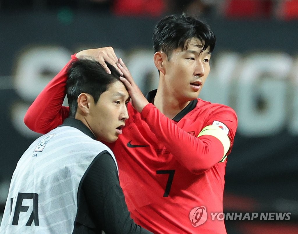 Son Heung-min of South Korea (R) embraces teammate Lee Kang-in following their team's 1-0 victory over Cameroon in the teams' men's football friendly match at Seoul World Cup Stadium in Seoul on Sept. 27, 2022. (Yonhap)