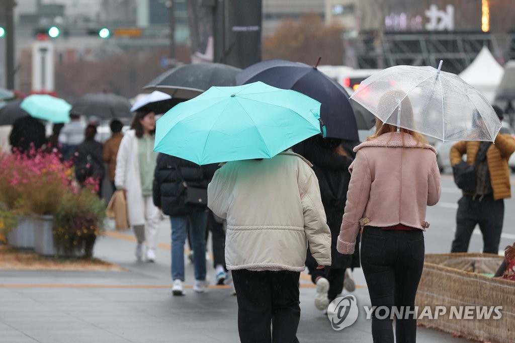 서울 광화문광장 인근에서 우산을 쓴 시민들이 이동하고 있다. [연합뉴스 자료사진]