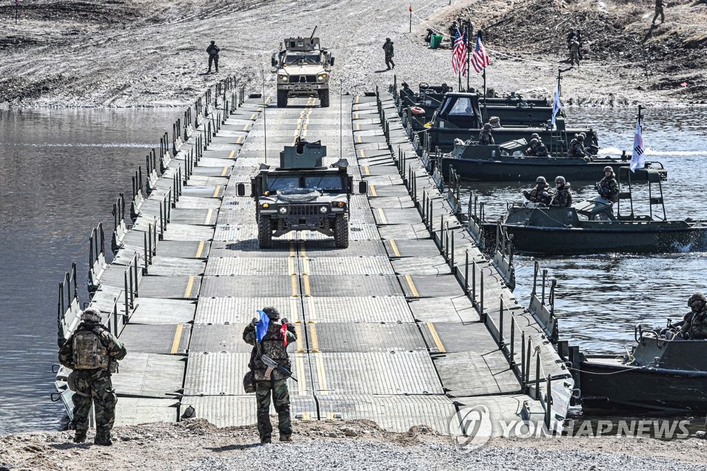 Military vehicles cross a makeshift bridge assembled by South Korean and U.S. troops during combined river-crossing drills at a training ground in the border county of Yeoncheon, 62 kilometers of Seoul, in this photo provided by the South's Army on March 15, 2023. The drills kicked off on March 6 and will run until March 17. (PHOTO NOT FOR SALE) (Yonhap) 
