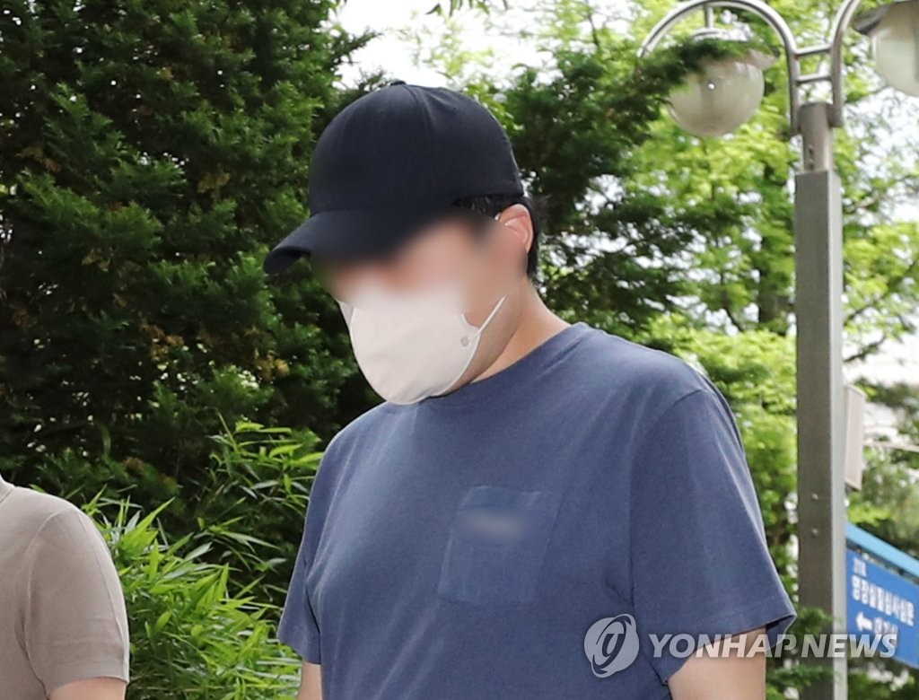 A 33-year-old man attends a court hearing for charges of causing a serious brain injury to his 2-month-old son by shaking him too violently at the Incheon District Court on March 22, 2023. (Yonhap) 