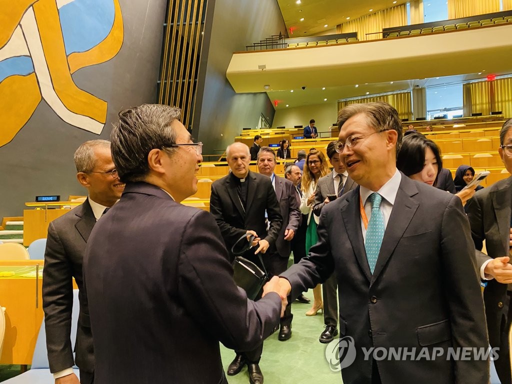 South Korean Ambassador to the United Nations Hwang Joon-kook (R) is congratulated by his Japanese counterpart, Kimihiro Ishikane, after South Korea was elected as a nonpermanent member of the 15-member United Nations Security Council for a two-year term starting on Jan. 1, 2024, in a vote at the U.N. General Assembly in New York on June 6, 2023. (Yonhap)