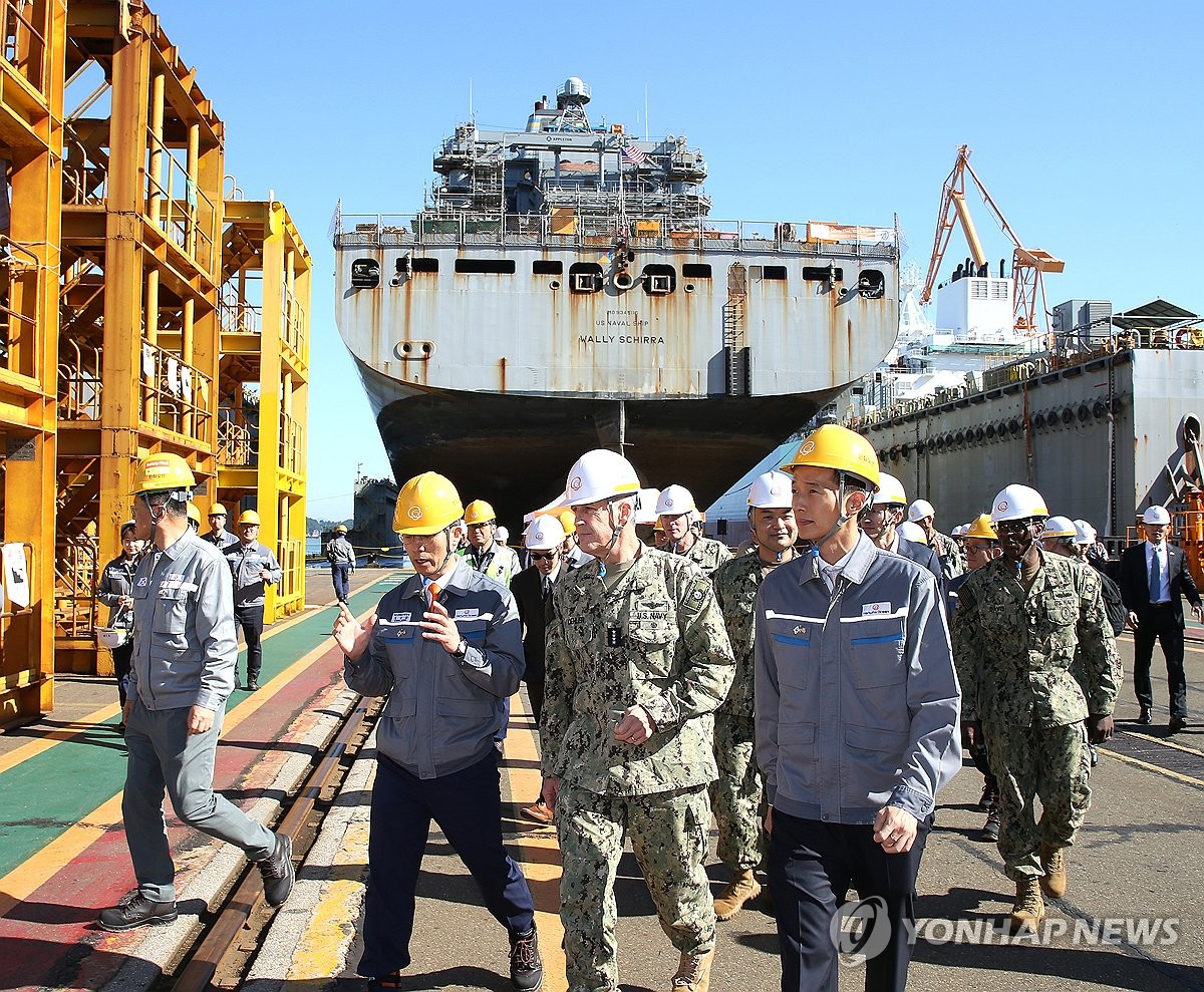 This file photo provided by Hanwha Ocean Co. shows Adm. Steve Koehler (2nd from R, front row), commander of the U.S. Pacific Fleet, visiting the South Korean shipbuilder's shipyard on the country's southeastern island city of Geoje on Oct. 24, 2024, where the USNS Wally Schirra, a U.S. Navy cargo ship, has been receiving maintenance, repair and overhaul services since Sept. 2 under a deal between Hanwha and the U.S. Navy. (PHOTO NOT FOR SALE) (Yonhap)